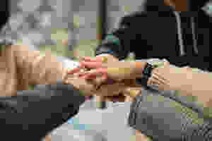 <img src="hands.jpg" alt="people joining hands together in the middle representing team work">