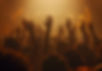 Silhouettes of people with raised hands in worship during a Christian gathering
