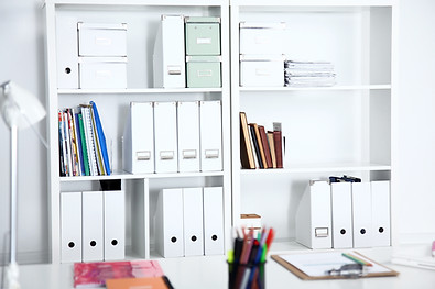 A wall of office supplies behing a desk