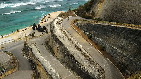 Melasti Beach Bali with white sand, turquoise waves, and scenic limestone cliffs in Ungasan