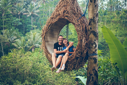 Honeymoon couple posing in traditional Bali jungle with scenic backdrop