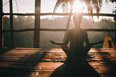Young woman meditating in Ubud Bali surrounded by tropical jungle and peaceful atmosphere