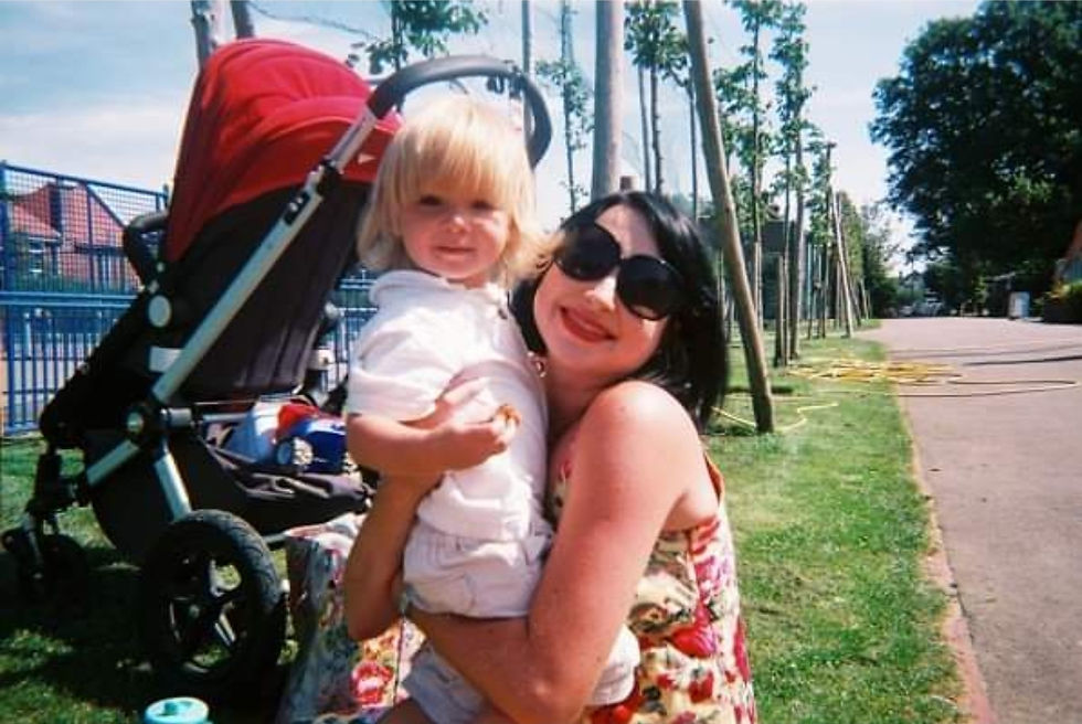 In the park with my firstborn and pregnant with my daughter. Wearing the pretty sundress and red lipstick that were so important to me
