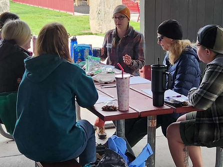 Women participating in an EmpowHer Outdoors backpacking workshop, learning wilderness skills, gear setup, and confidence on the trail.