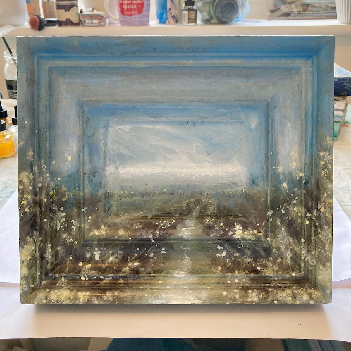 small painting of sussex landscape with path lined by trees and hedgerows full of spring blossom