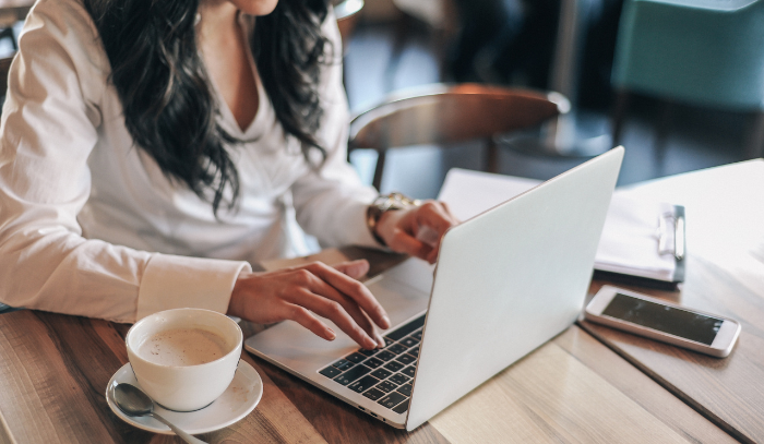 people sitting with laptops and documents