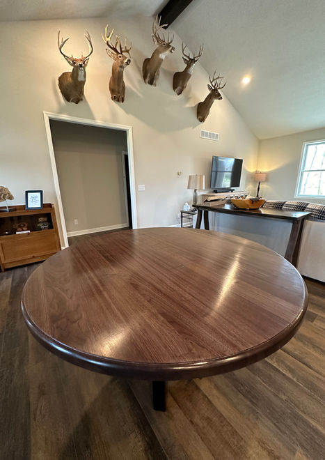A simple round table that was built from the walnut trees that were cut down from this client's property. A round table is great for keeping everyone a part of the conversation and perfect for game night.