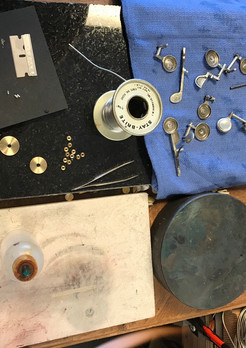 Replacing all pad retainer washers and spuds on the keys to an old wooden flute during an overhaul.