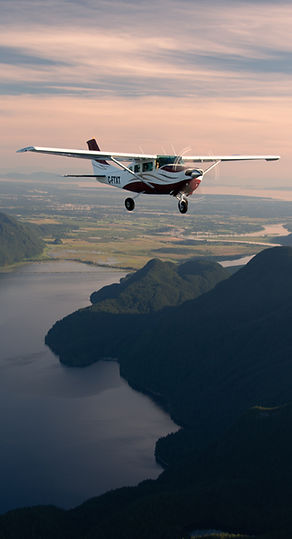 A cessna 206 at sunset looking over the greater Vancouver Area