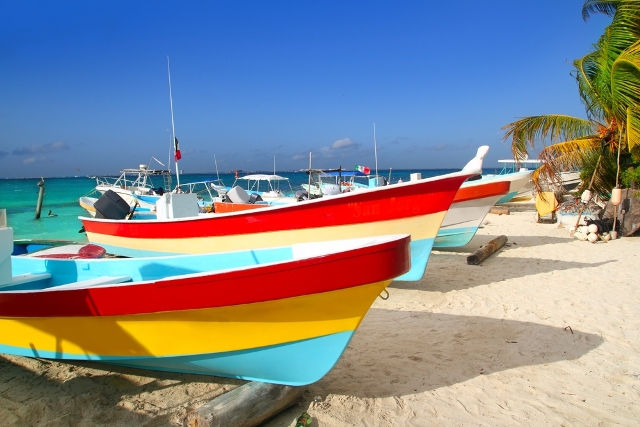 colorful-tropical-boats-beached-in-the-sand-Isla-Mujeres-Mexico.jpg