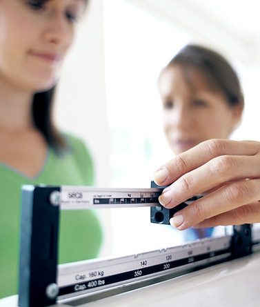 Woman using weight scale