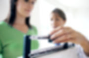 Doctor adjusting balance on weighing scale