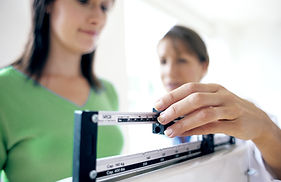 Woman on scale to Weigh herself