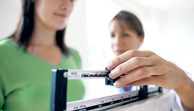Woman using weight scale