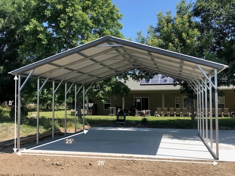 Freestanding gable-roof metal shelter on a concrete pad