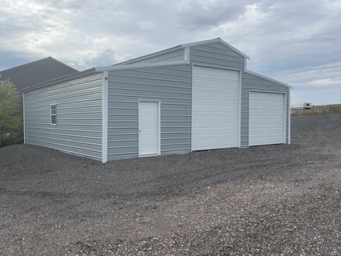 Gray metal building with a raised center section and lower side sections