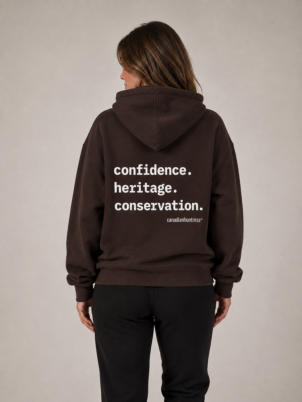 Canadian Huntress® The Hoodie No. 06 in dark brown, fleece hoodie with white Confidence Heritage Conservation on the back