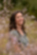 Tessa Sinclair, Licensed Marriage & Family Therapist, smiling in a field of flowers