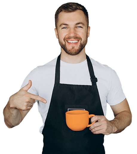 male-barista-coffee-shop-holding-cup-by-counter.png