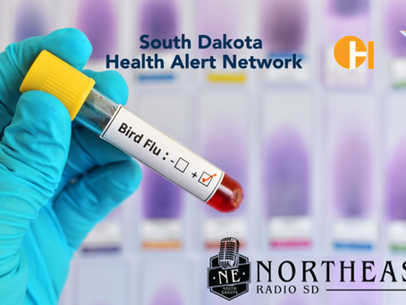Gloved hand holds a Bird Flu blood sample vial; South Dakota Health Alert Network and Northeast Radio SD logos in background.