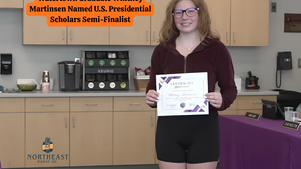 Smiling woman holds a certificate in a break room; banner reads Watertown Graduate Whitney Martinsen Named U.S. Presidential Scholars Semi-Finalist