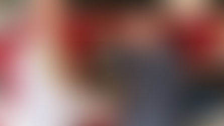 Two men shaking hands in front of a fire truck, one holding a firefighter helmet. Background shows "Watertown" emblem. Mood is positive.