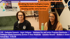 Two women are seated with microphones in a radio studio. Text displays "Breaking the Cycle" and "Codington Connects." Walls are beige.