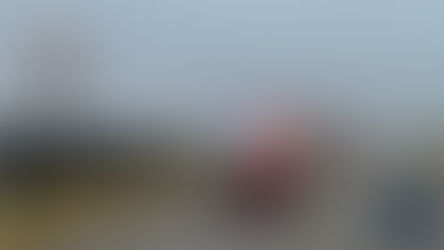 Police vehicles with flashing lights respond to an overturned white car in a field. Overcast sky. "NORTHEAST RADIO SD" logo visible.