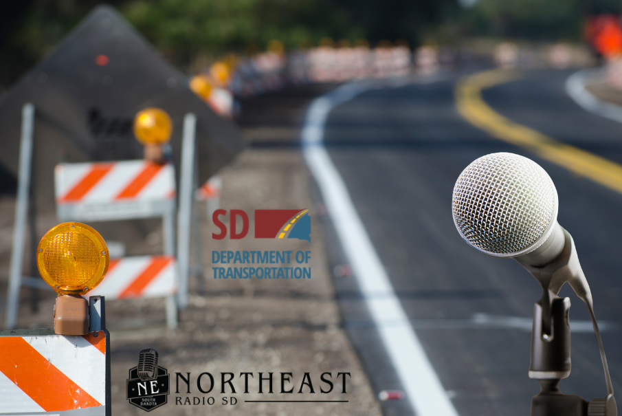 Roadwork barriers on a curving highway with a microphone foreground and SD Department of Transportation, Northeast Radio SD logos.