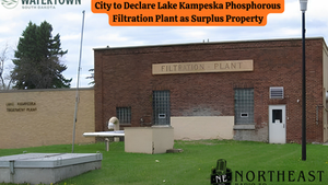 Brick filtration plant with sign declares it surplus property. "City of Watertown" and "Northeast Radio SD" logos. Green lawn; cloudy sky.