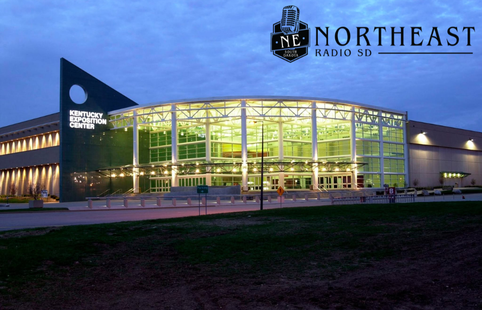 Illuminated Kentucky Exposition Center at dusk with NORTHEAST RADIO SD logo in the sky-blue background.