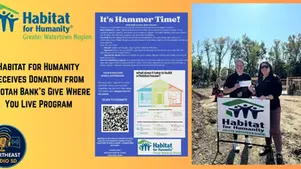 Two people hold a donation check beside a Habitat for Humanity sign. Blue poster titled "It's Hammer Time!" in background, construction site visible.