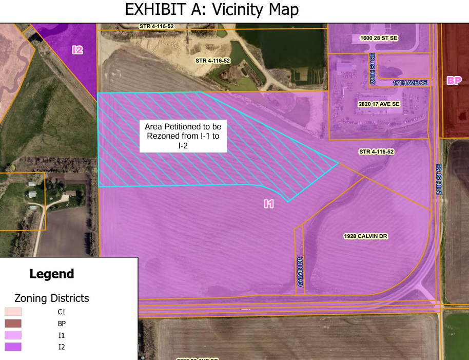 Zoning vicinity map with purple-highlighted I1/I2 area and hatched petition zone labeled Area Petitioned to be Rezoned from I-1 to I-2
