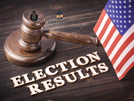 Wooden gavel beside U.S. flag on dark table with ELECTION RESULTS text and Northeast Radio SD logo