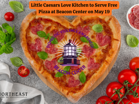 Heart-shaped pizza with toppings, fresh tomatoes, and basil on a table. Text: "Little Caesars to serve free pizza May 19 at Beacon Center."