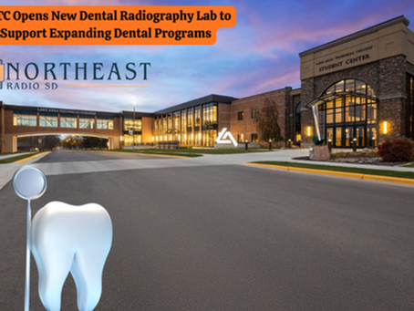 Exterior of Lake Area Technical College at dusk with a giant tooth and dental tool. Sign announces new dental radiography lab.