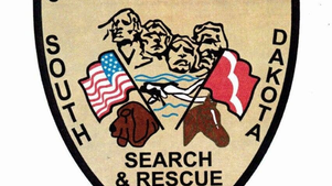 Coddington County South Dakota Search & Rescue shield logo with mountains, flags, and dog heads; EST. 1993