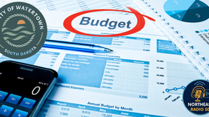 Budget planning sheet with "Budget" circled in red. Includes calculator, pen, and pie chart. Logos for Watertown, SD, and Northeast Radio SD.