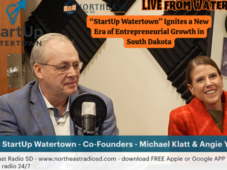 Two people sit at a table with microphones, smiling. Text promotes "StartUp Watertown" as an entrepreneurial initiative in South Dakota.