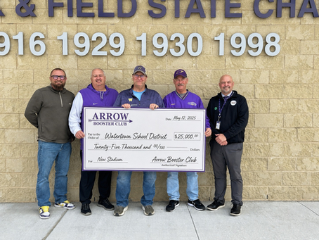 Five men stand smiling, holding a large check for $25,000 from Arrow Booster Club to Watertown School District for a new stadium.