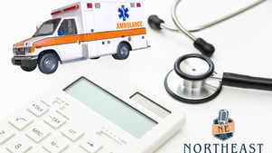 Ambulance, stethoscope, and calculator on white background with Northeast Radio SD logo, suggesting healthcare costs.