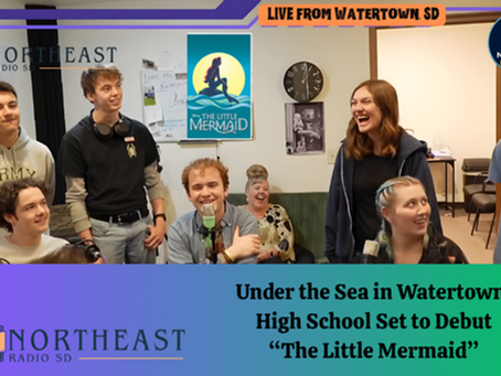 Smiling group in radio studio discussing "The Little Mermaid" debut. Posters, microphones, and a mix of casual and excited atmosphere.