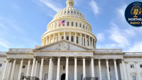 US Capitol building under clear blue sky, American flag waving. "Northeast Radio SD" logo in top right corner. Majestic and calm.