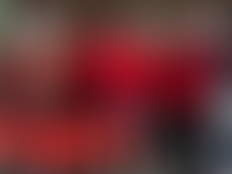 Group of eight people in red and black attire smiling indoors. Text overlay: "Watertown’s Ranum Continues Service as Governor’s Tourism Advisory Board Elects Leadership."