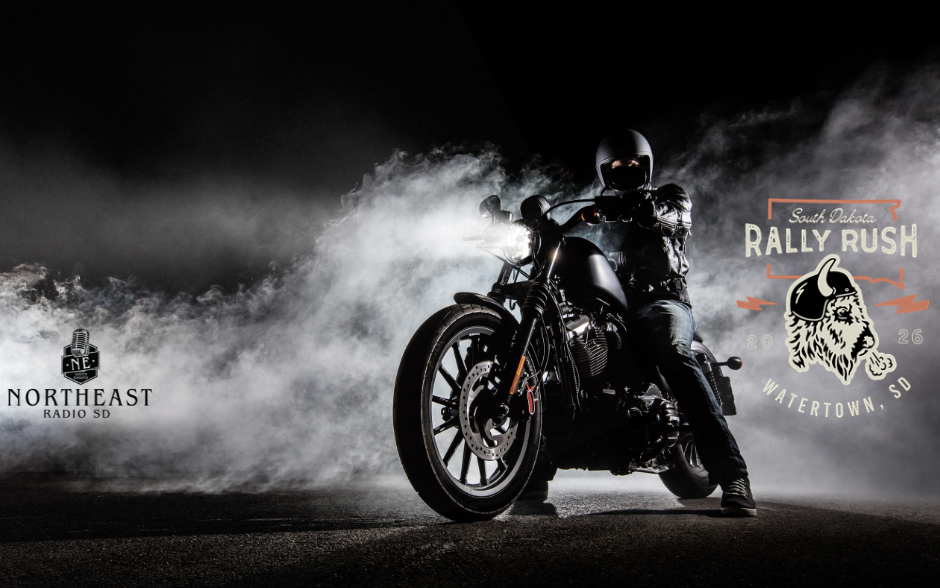 Motorcyclist in helmet on black bike in smoke; logos read Northeast Radio SD and South Dakota Rally Rush Watertown, SD 2026.