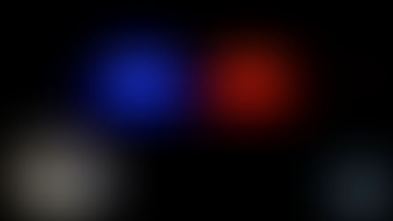 Sheriff badge and police lights, blue and red, against a dark background. Logos for "Northeast Radio SD" and "Brookings County" visible.