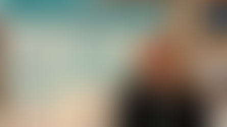 Smiling woman stands by a poster titled "How Generations of Teacher Education Impact Special Education Inclusion" at a conference.