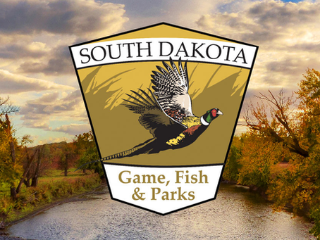 South Dakota Game, Fish & Parks logo with a pheasant in flight. Background features a serene river, autumn trees, and a cloudy sky.