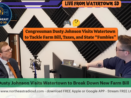 Two men in a radio studio discuss the Farm Bill. Black soundproof panels and a screen on the table. "Live from Watertown SD" text.