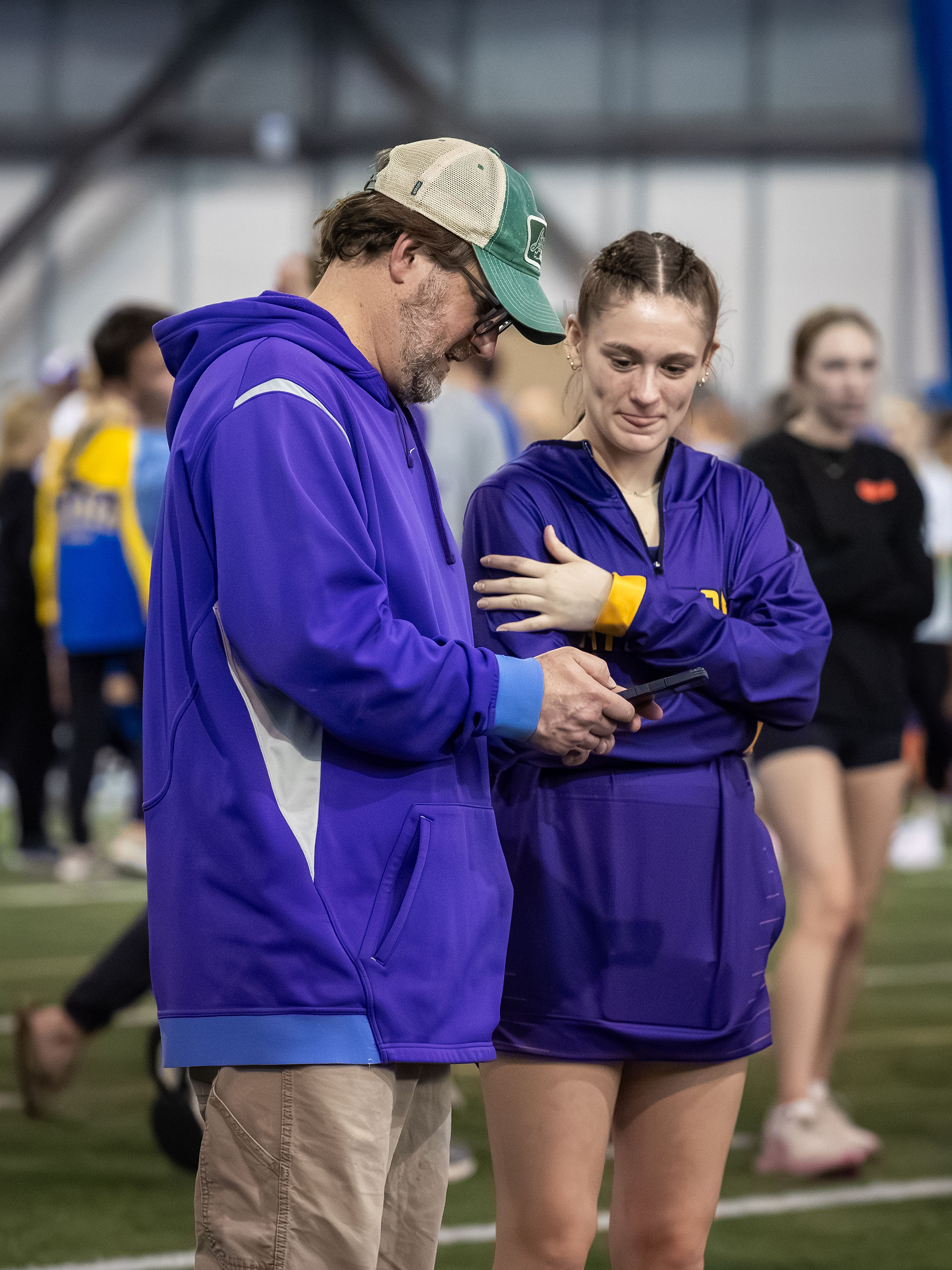 Katie Flemming talks with her pole vault coach.